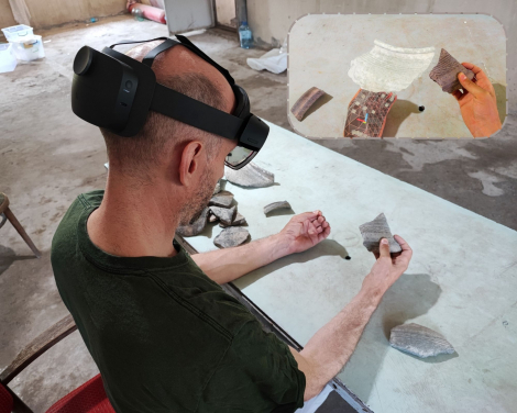 HKU Faculty of Arts Professor Peter J. Cobb compares the 3D model of a virtual pottery sherd with an adjoining real sherd. The small photo is what he sees in the MR headset. (Photo credit: HKU Faculty of Arts)
